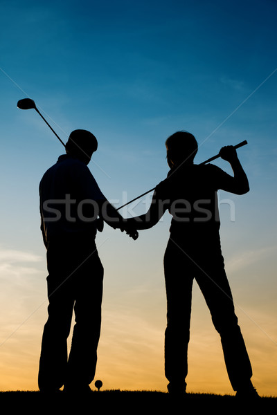 Senior couple playing Golf at sunset Stock photo © Kzenon