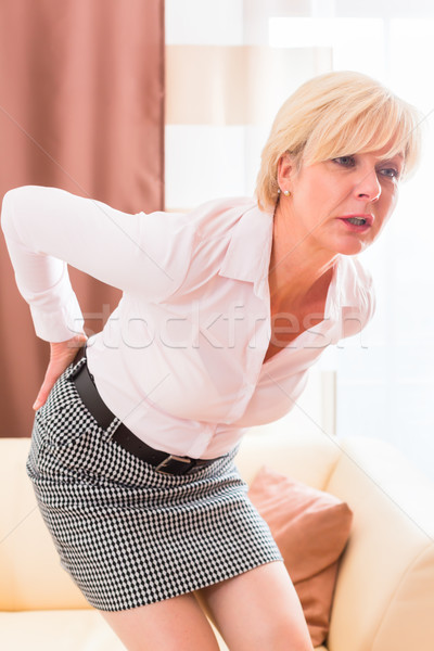 Senior having back pain at home Stock photo © Kzenon