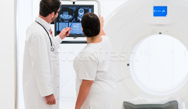 Doctor and nurse analyzing data of CT scan Stock photo © Kzenon