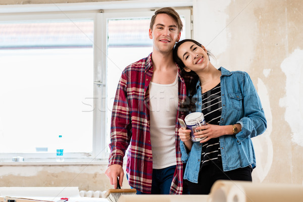 Portrait of a happy young couple holding tools for home remodeli Stock photo © Kzenon