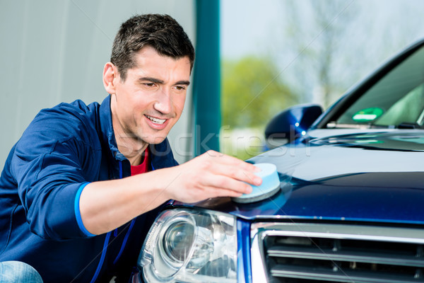 Man using an absorbent towel for drying the surface of a car Stock photo © Kzenon