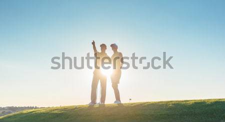 Sziluett férfi mutat áll partner kilátás Stock fotó © Kzenon