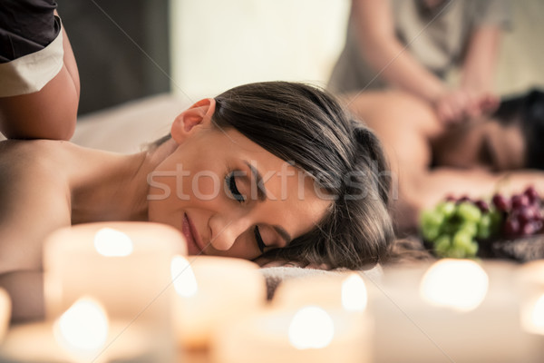 Beautiful young woman relaxing with her partner during Thai massage Stock photo © Kzenon