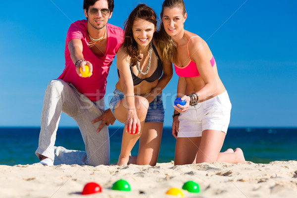 Man and women playing boule on beach Stock photo © Kzenon