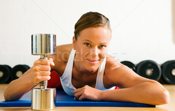 Woman with dumb bell in the gym Stock photo © Kzenon