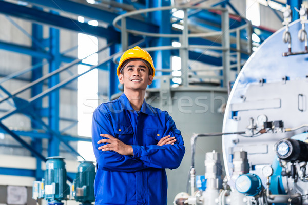 Stock photo: Proud Asian worker in production factory