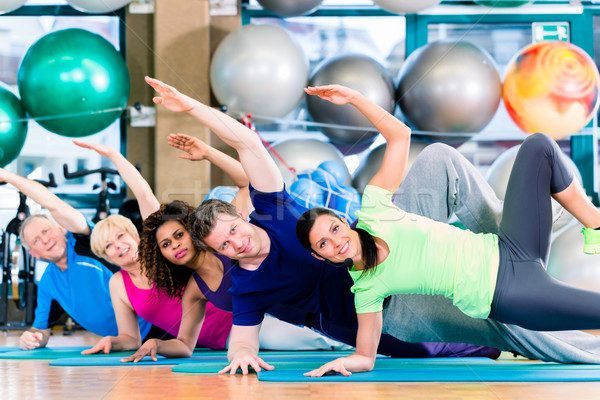 Gymnastic group in gym exercising and training Stock photo © Kzenon