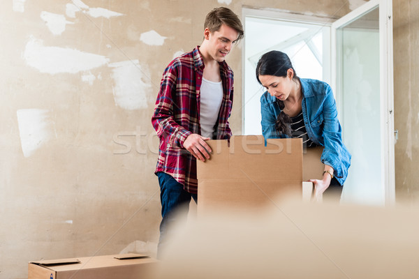 Young woman bringing open box moving in with her boyfriend into  Stock photo © Kzenon