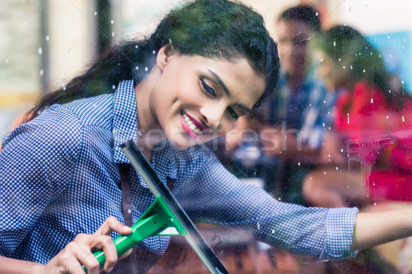 Indian girl cleaning windows Stock photo © Kzenon