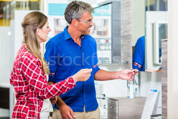 Shop assistant in hardware store counseling customer about lavat Stock photo © Kzenon