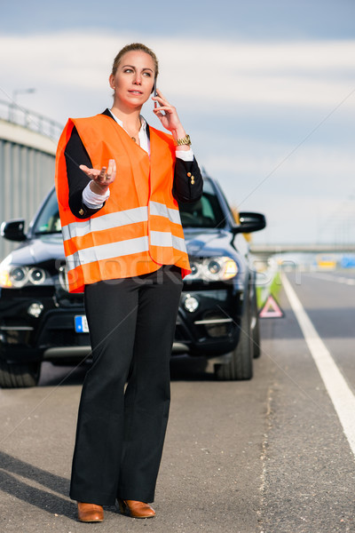 Woman with car breakdown calling towing company Stock photo © Kzenon