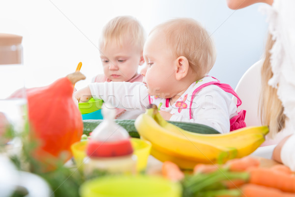 Cute baby girl eating healthy solid food in a modern daycare cen Stock photo © Kzenon