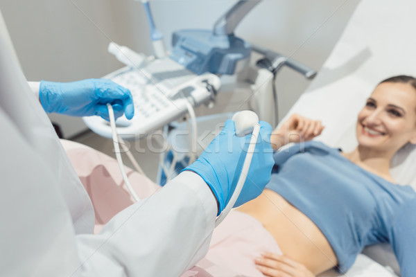 Gynecologist attempting ultrasonic examination of patient Stock photo © Kzenon