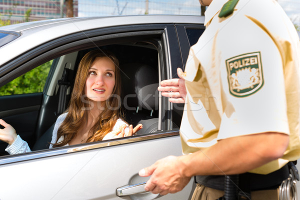 Police - woman in traffic violation getting ticket Stock photo © Kzenon