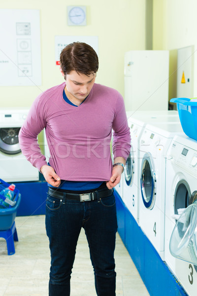 Student in a laundry with shrunk pullover Stock photo © Kzenon