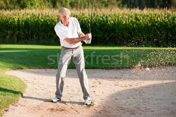Senior golf player in sand trap Stock photo © Kzenon