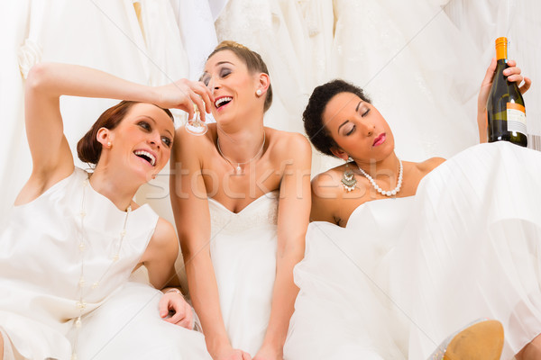 Brides drinking too much in wedding shop or store Stock photo © Kzenon