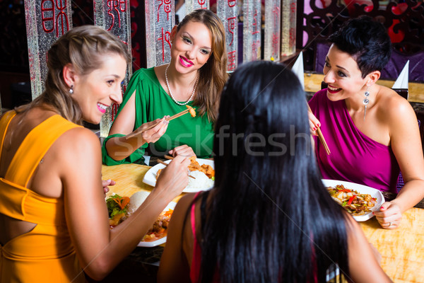 Stock photo: Young people eating in Asia restaurant