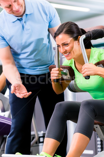 Woman with personal trainer doing sport und fitness Stock photo © Kzenon