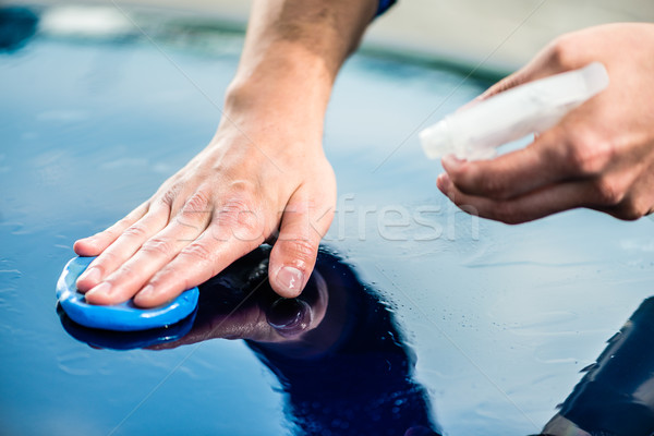 Close-up of male hands waxing a blue car at auto wash Stock photo © Kzenon
