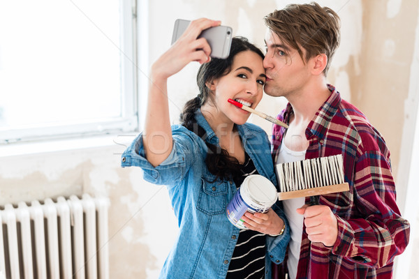 Young couple making a selfie while working to the renovation of  Stock photo © Kzenon