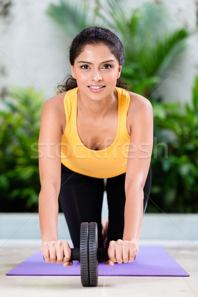 Young woman doing stretching exercise indoors Stock photo © Kzenon