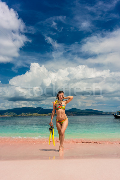 Beautiful young woman holding snorkeling equipment at Pink Beach Stock photo © Kzenon