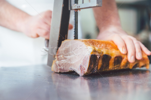 Butcher cutting meat in butchery Stock photo © Kzenon