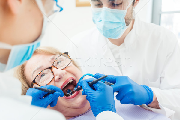 Stock photo: Dentist during treatment of senior patient woman