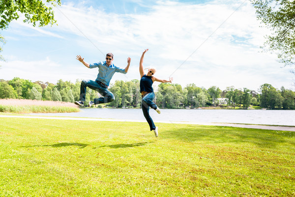Excited young couple jumping Stock photo © Kzenon