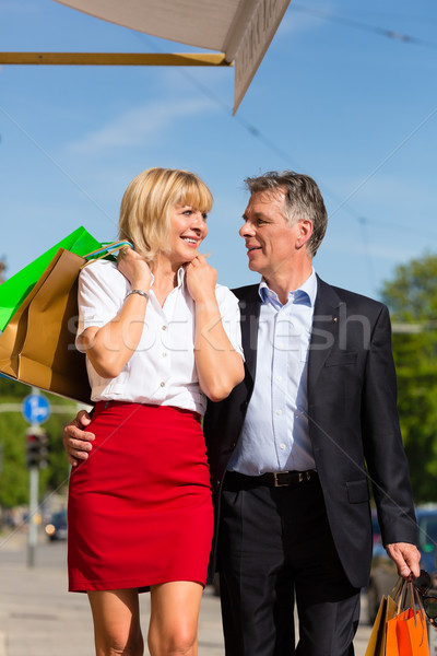 Mature couple strolling through city shopping in spring Stock photo © Kzenon