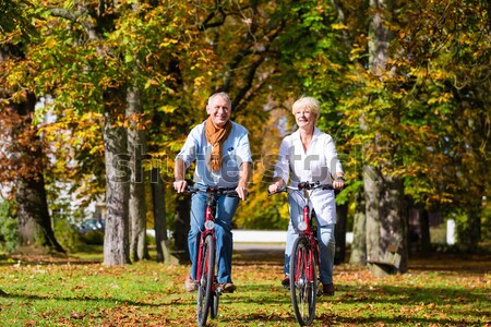 Seniors exercising with bicycle Stock photo © Kzenon