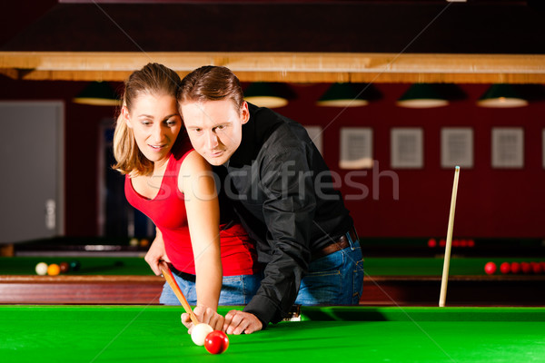 Couple playing billiards Stock photo © Kzenon