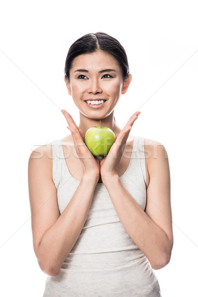 Thoughtful young Asian woman holding a green apple Stock photo © Kzenon