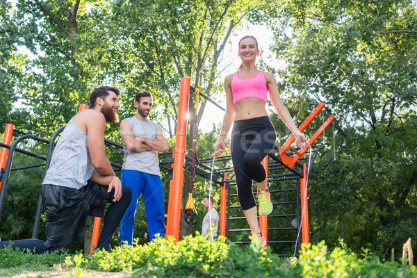 Beautiful woman jumping rope in the applauses of her friends dur Stock photo © Kzenon