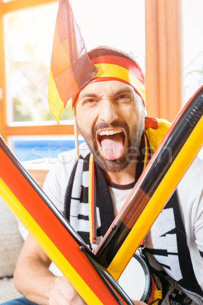 Young man cheering for the German soccer team Stock photo © Kzenon