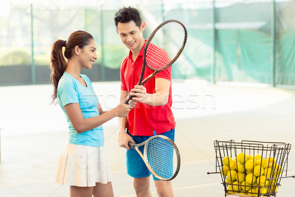 Tennis instructor teaching a beginner player the correct grip Stock photo © Kzenon