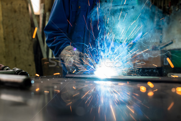 Welder in his workshop welding metal Stock photo © Kzenon