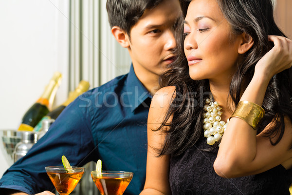 Man and woman in asia at bar with cocktails Stock photo © Kzenon