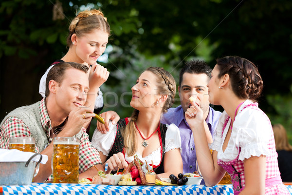 In Beer garden - friends on a table with beer Stock photo © Kzenon