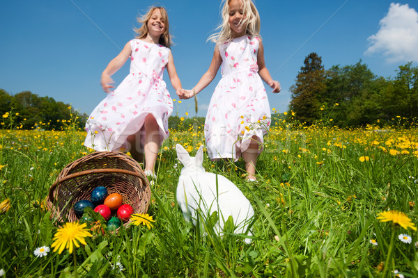 Stock photo: Children on Easter egg hunt with bunny