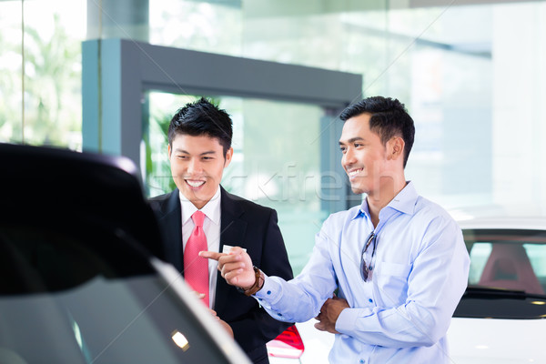 Asian Car Salesman selling auto to customer Stock photo © Kzenon