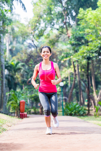 Asian woman running in park for fitness Stock photo © Kzenon