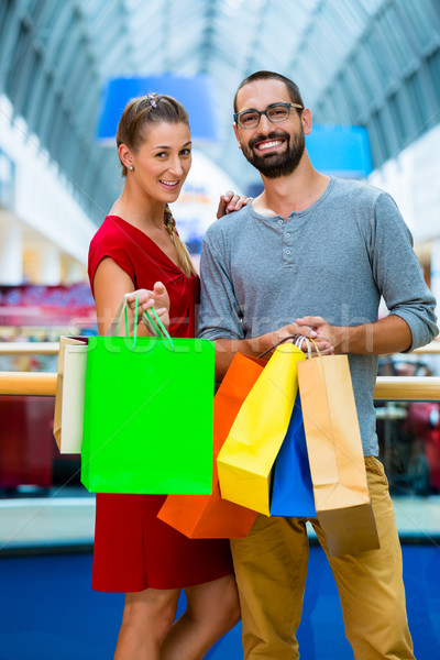 Man and woman in shopping mall with bags Stock photo © Kzenon