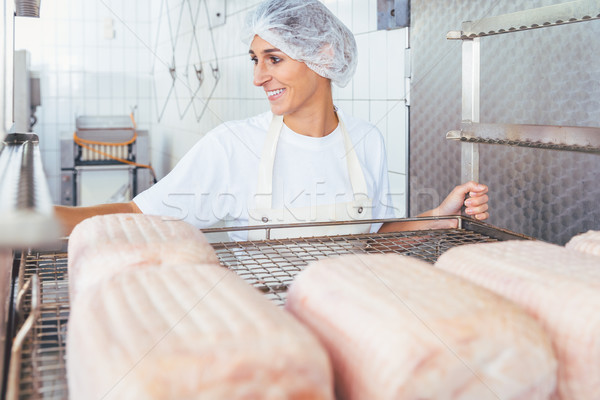 Woman in butchery processing meat Stock photo © Kzenon