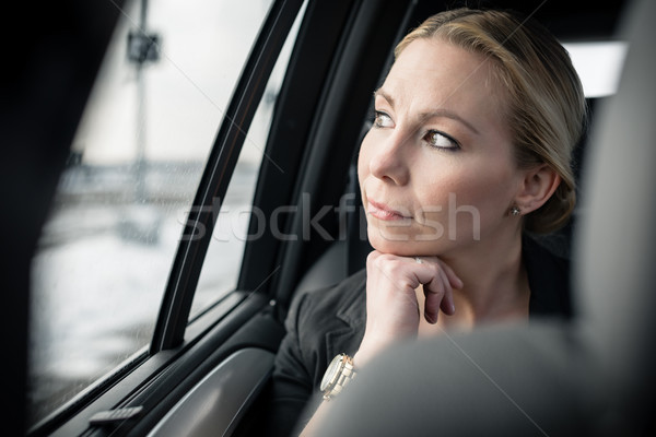 Thoughtful businesswoman travelling in car Stock photo © Kzenon
