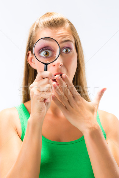 Stock photo: Woman looking through magnifying glass or loupe