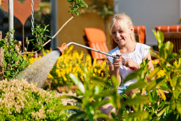 Happy child watering flowers Stock photo © Kzenon