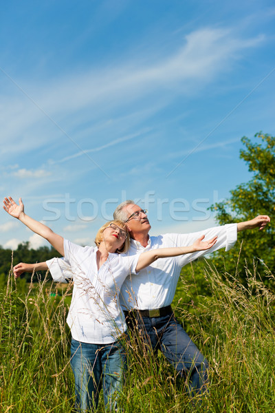 Happy senior couple having fun outdoors in summer Stock photo © Kzenon