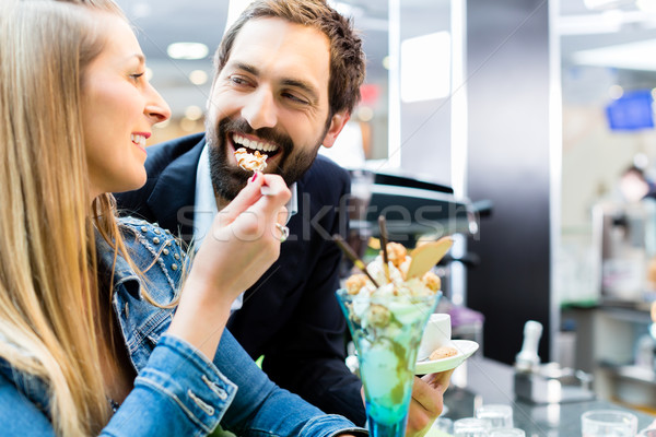 Couple enjoying an ice cream sundae in cafe Stock photo © Kzenon